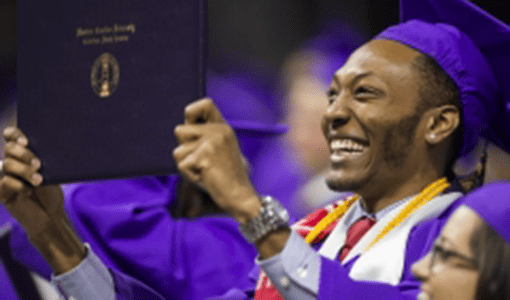 Happy student holding diploma