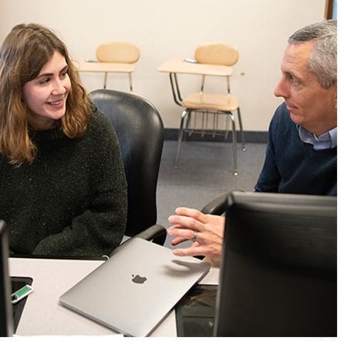 Beau Lewis (left) consults with Dr. Russell Smith, associate professor of geography, on her transportation research project.