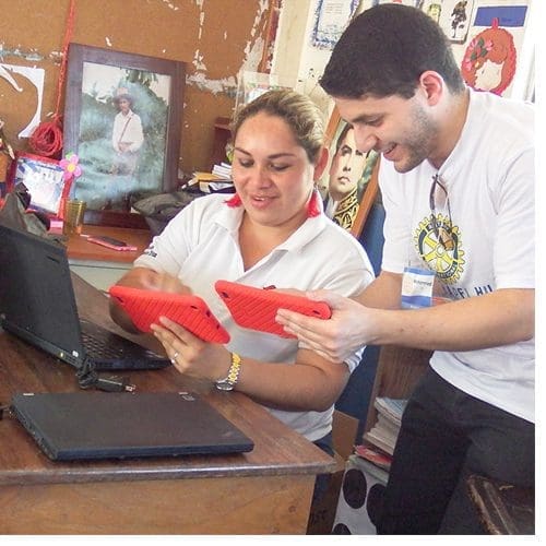 Mohammed Eid training teachers at Trinidad Norte School to use a tablet during a service trip to Nicaragua.
