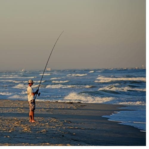 A fisherman tries his luck along the surf at Carolina Beach's Freeman Park.