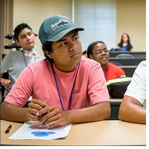 Latino high school students attend a class taught by a UNCG professor.