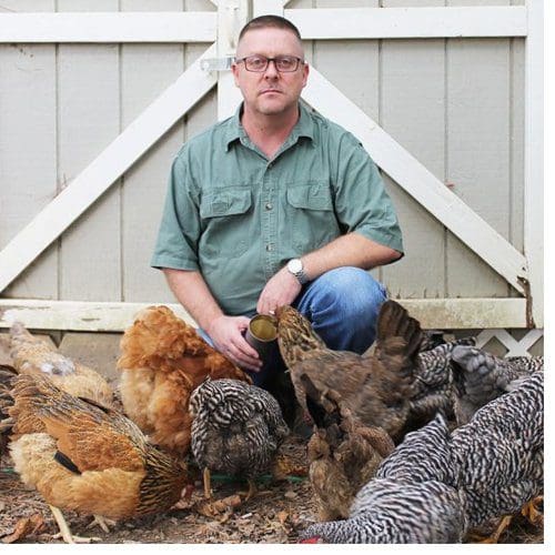 NC Farm School graduate James Payne of Franklin County tends chickens now and plans to add pasture-raised pigs with guidance from NC Farm School.