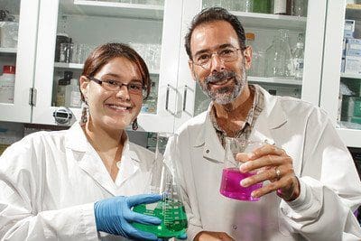 Dr. Ben Bahr and student holding beakers in a lab