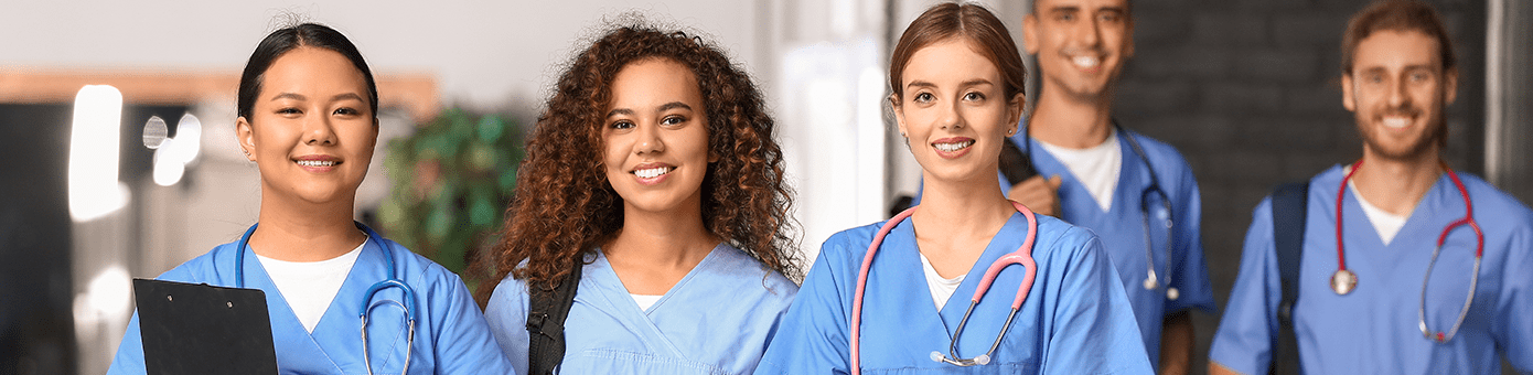 Smiling young doctors in blue scrubs