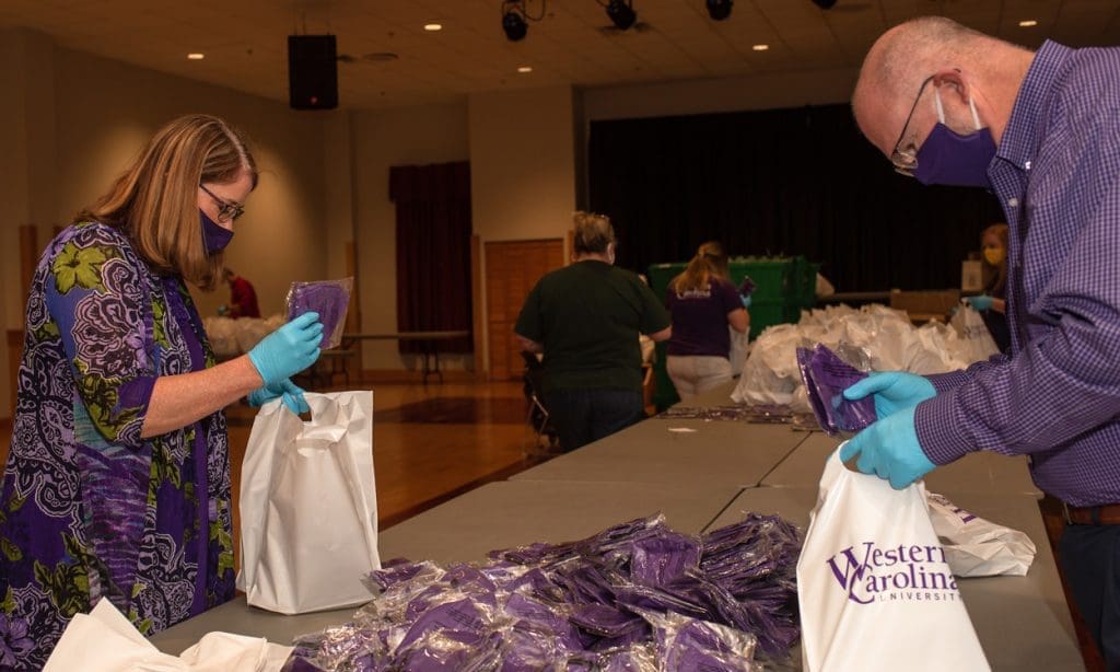 University employees prepare face coverings to distribute