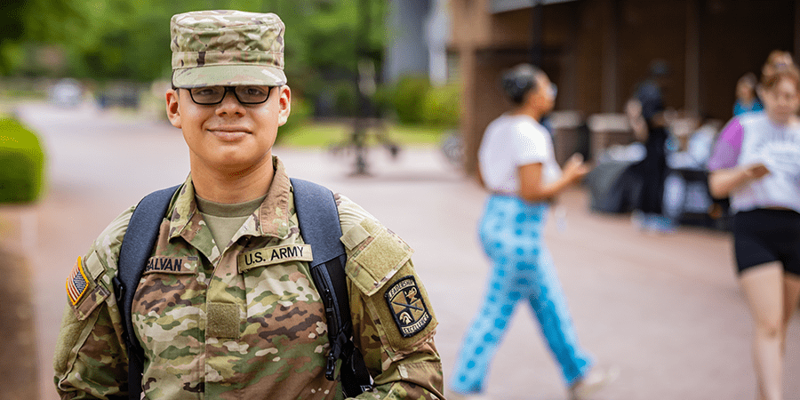 University student in military uniform wearing a backpack