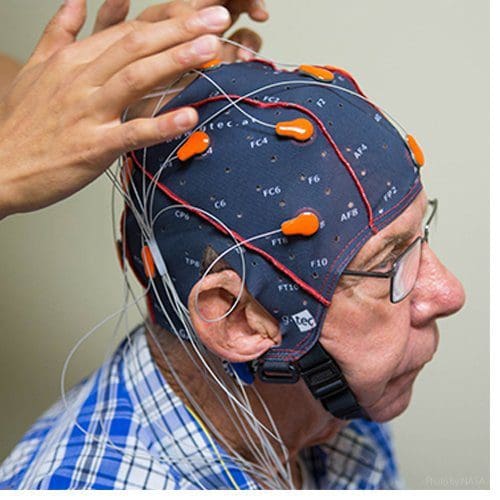 ECU's Dr. Kim administers a test to capture brainwaves testing for Alzheimer's and dementia.