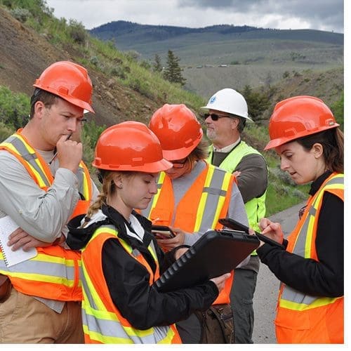 WCU geology students and recent alumni (from left) Richard Pedigo, Courtney Hartman, Holly Hurding-Jones and Eliza Hurst check their notes during a field training session in Yellowstone National Park with U.S. government engineering geologist Doug Anderson (background).